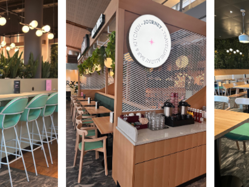 Kaféinteriør med grøne planter, moderne innreiing og sitjeplassar. Skilt for "Coffee & Breakfast" og "Lunch & Dinner" visast. Lyse og innbydande rom med stolrader ved disken og spisebord