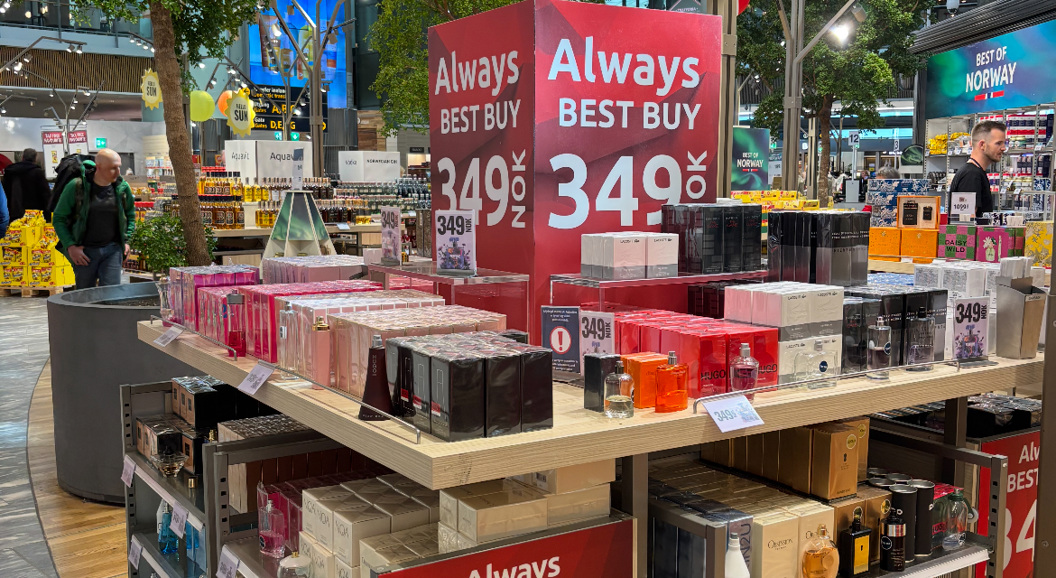 Perfume display in a store with red signs advertising a special offer of 349 NOK