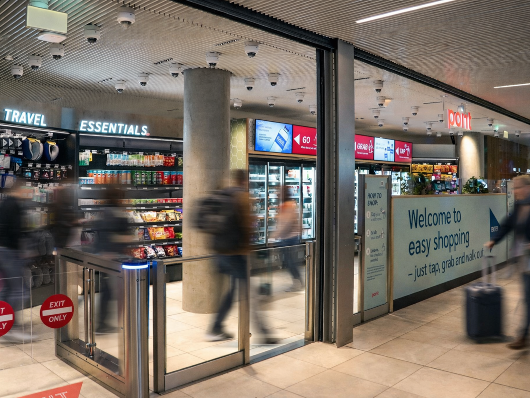 Convenience store with "Point" signage offering snacks, beverages, and coffee combo deals inside an airport terminal