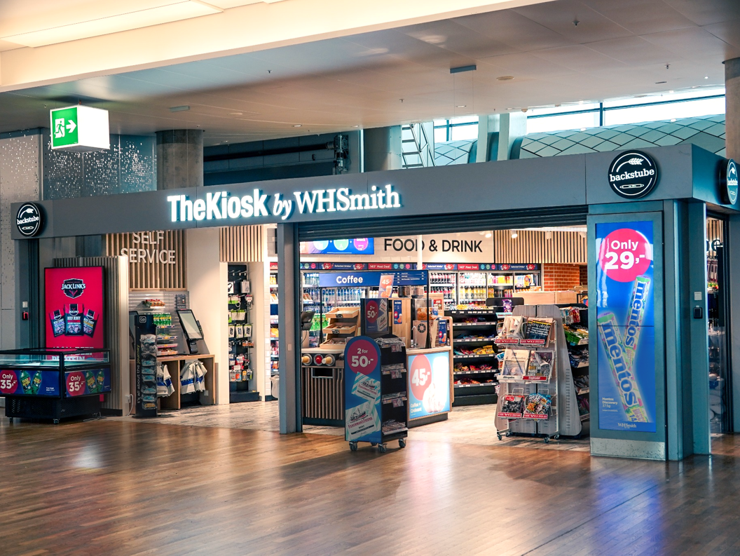 The Kiosk by WHSmith at an airport, featuring a selection of food, drinks, and magazines