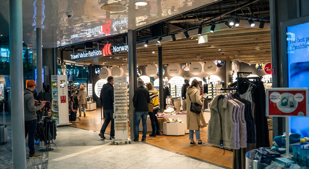 Person shopping for Persol sunglasses at an eyewear store display