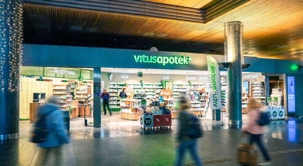 Vitusapotek storefront sign with green and white letters, pharmacy entrance