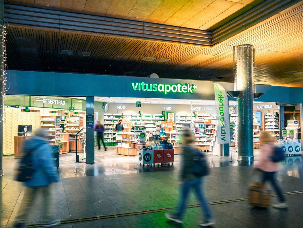 Vitusapotek storefront sign with green and white letters, pharmacy entrance
